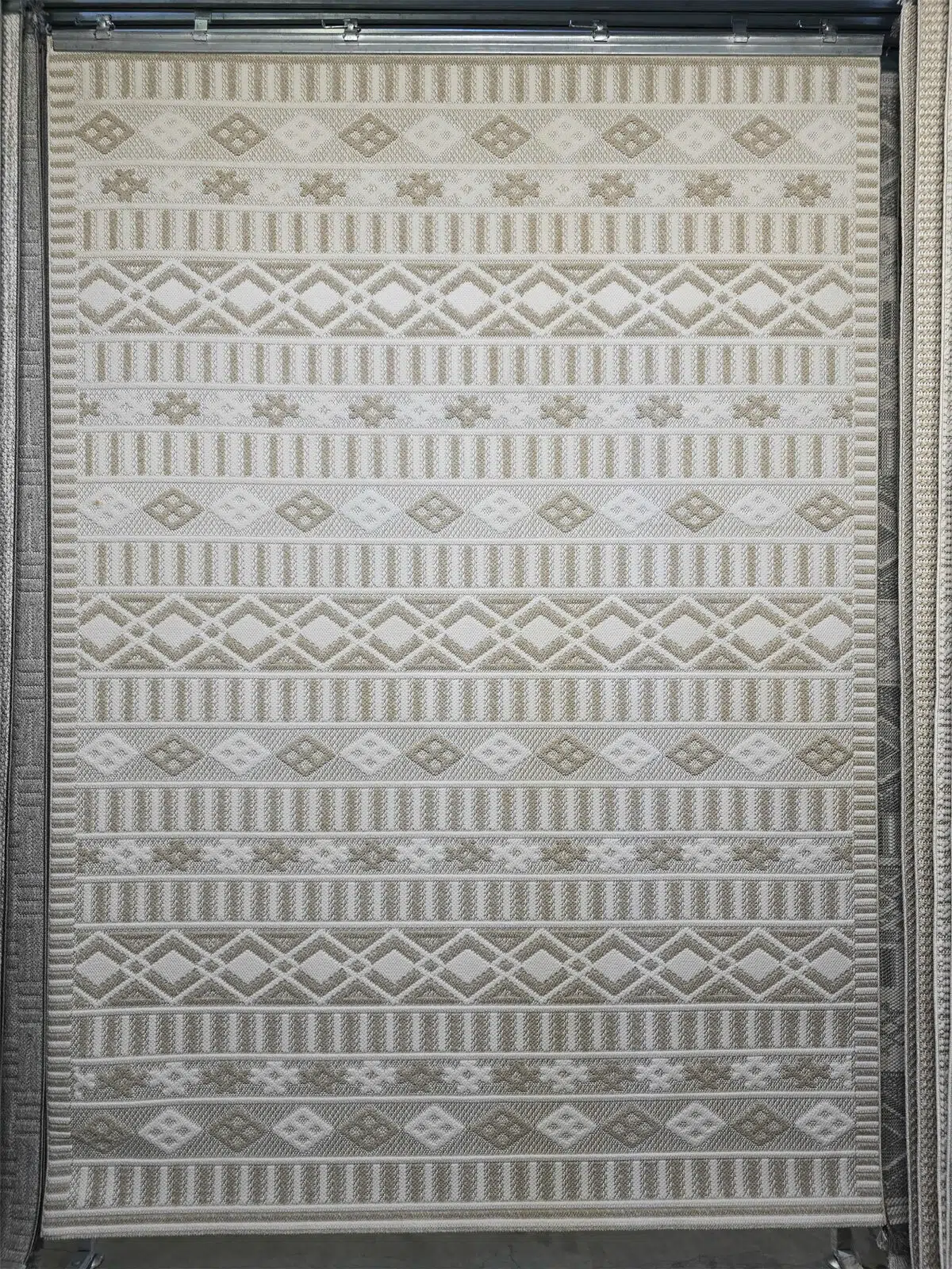 Full view of Radiant beige rug with layered diamond and stripe motifs