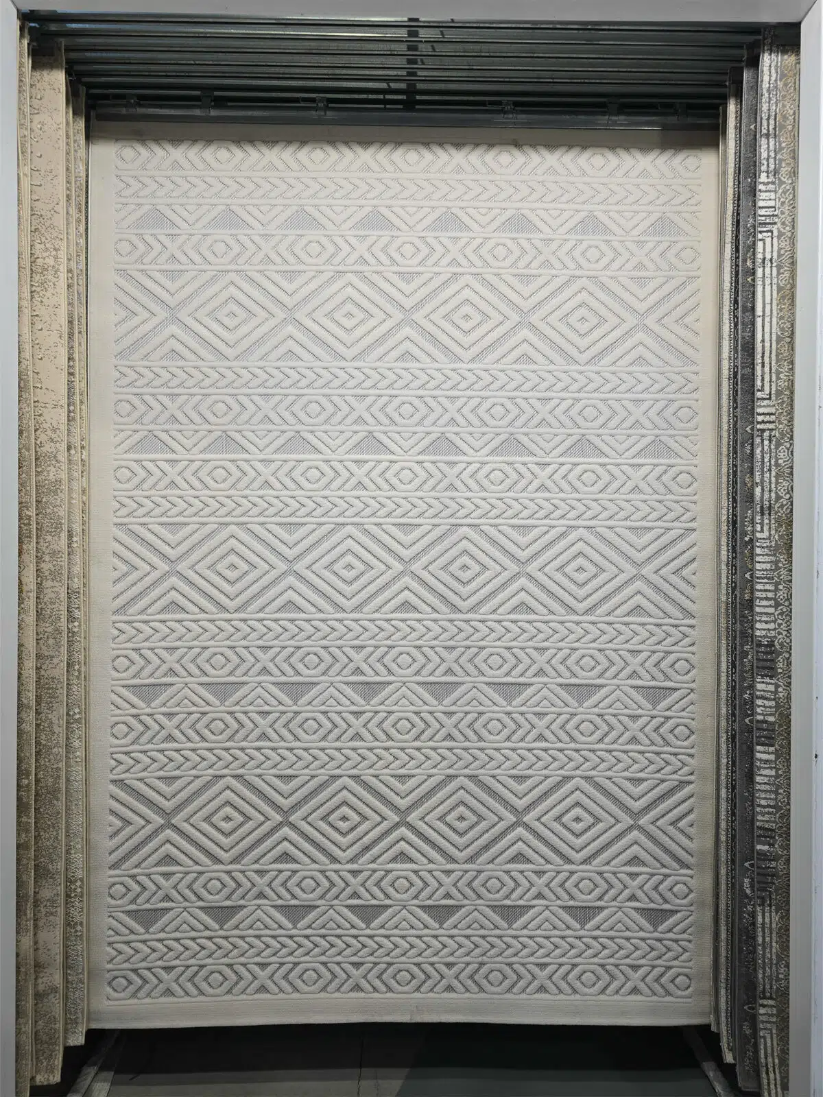 Full view of Luna rug showing white raised geometric patterns in a modern interior