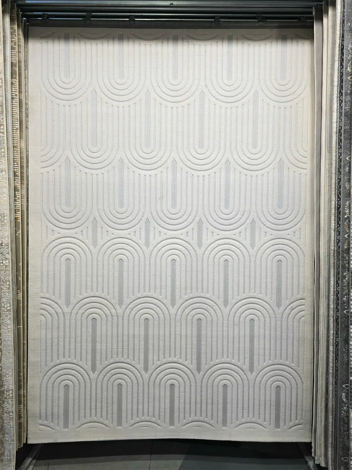 Full front view of Orion rug with arched repeating patterns in a modern white design