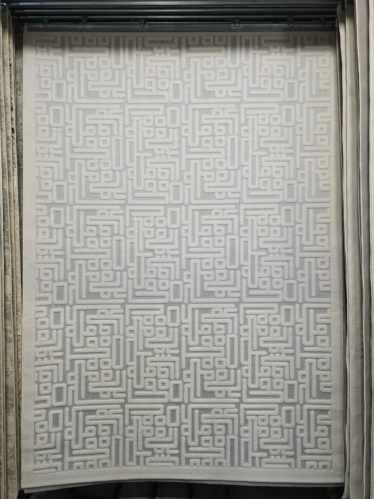 Full view of Vega Rug with modern Kufic pattern in soft ivory tones