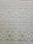 Close-up of Apollo Rug showing detailed geometric design in soft cream color