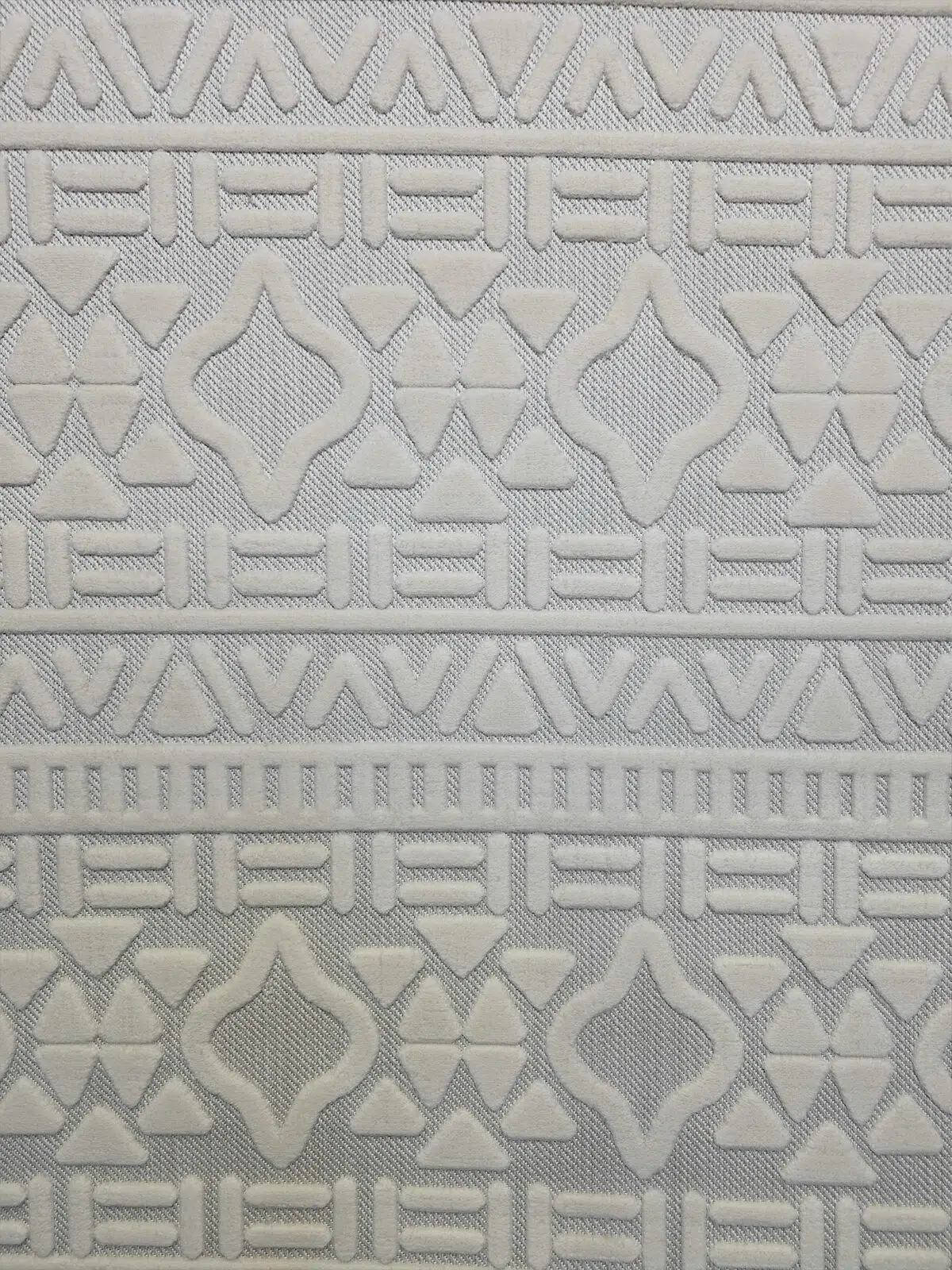 Close-up of Apollo Rug showing detailed geometric design in soft cream color