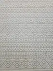 Close-up shot of Nova rug’s detailed white embossed diamond textures