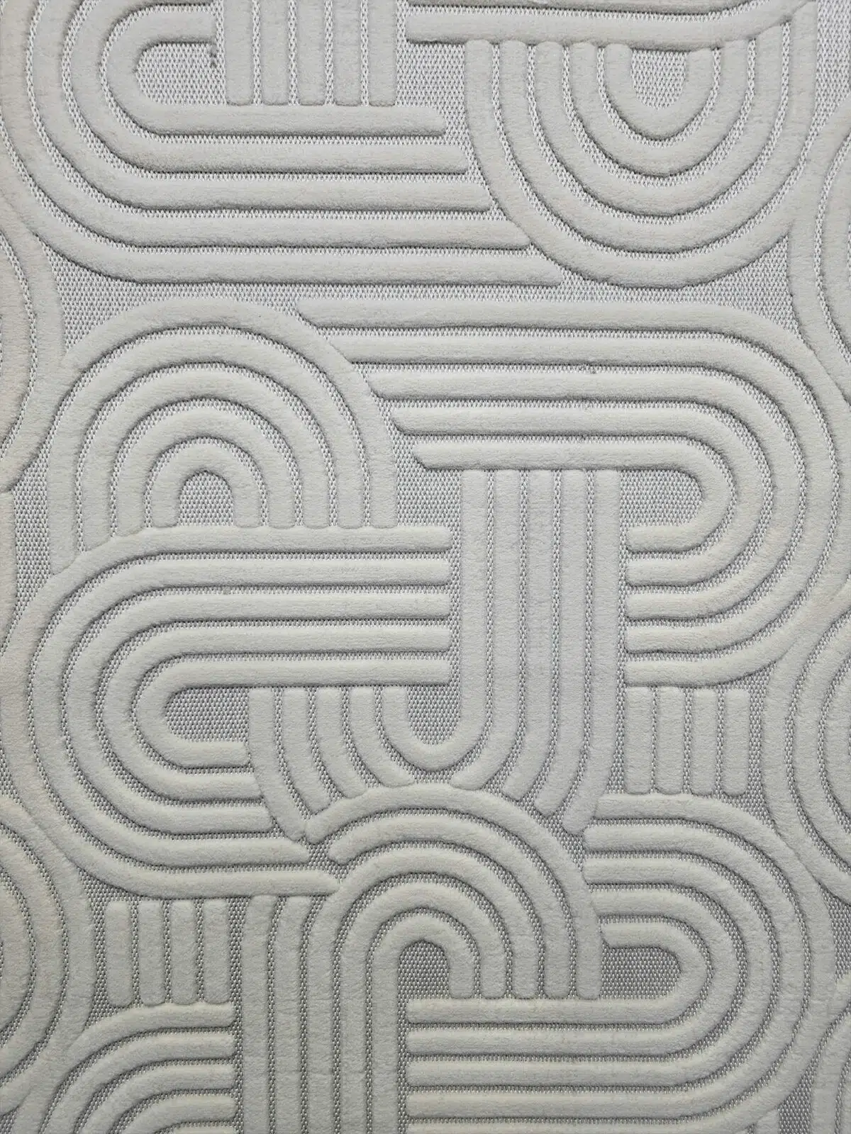 Close-up showing Sirius rug’s soft curved pattern and texture