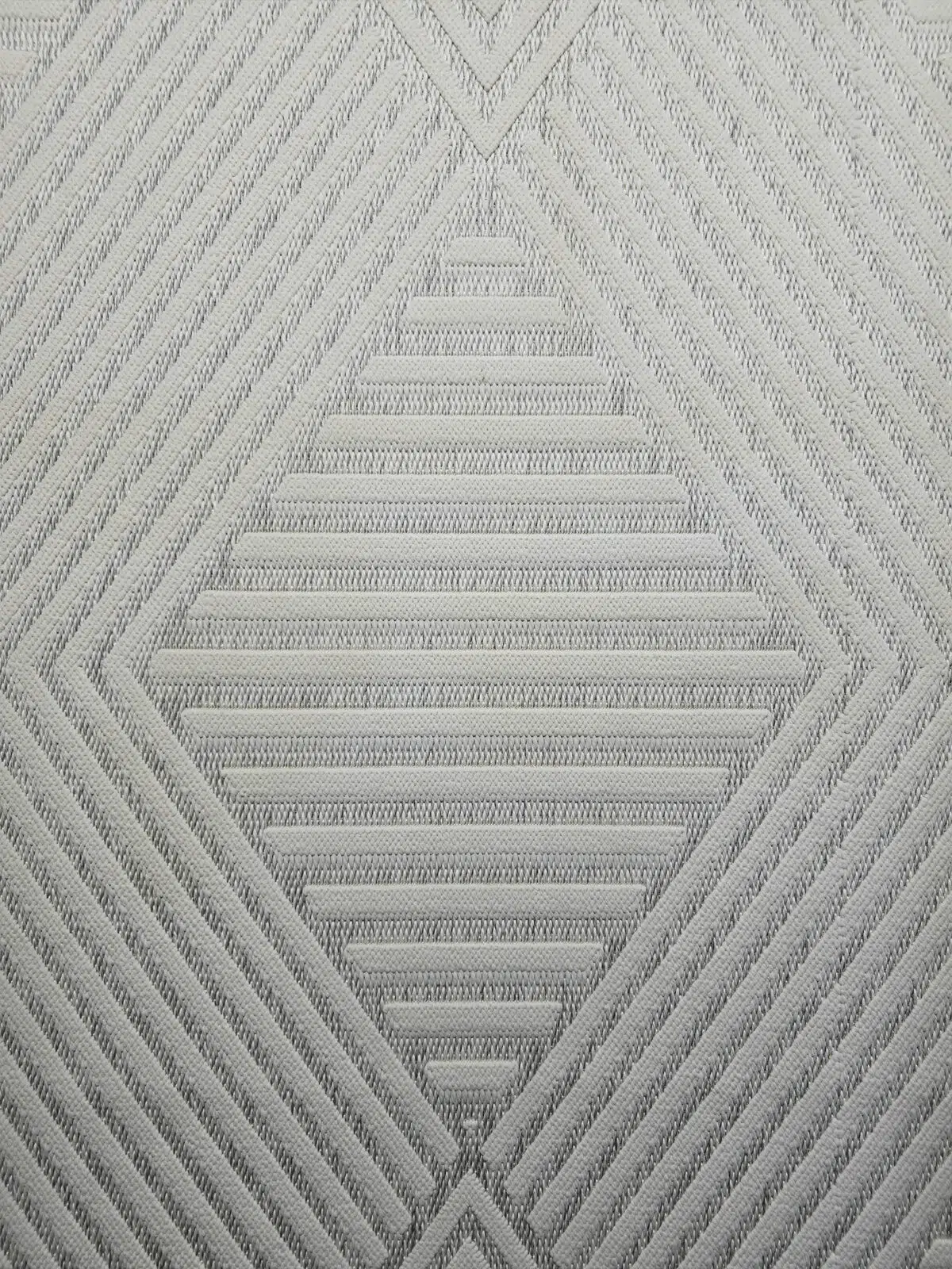 central diamond pattern of Solaris Rug in beige chevron texture