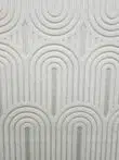 Mid-close detail of the Orion rug showing layered arched lines and soft surface