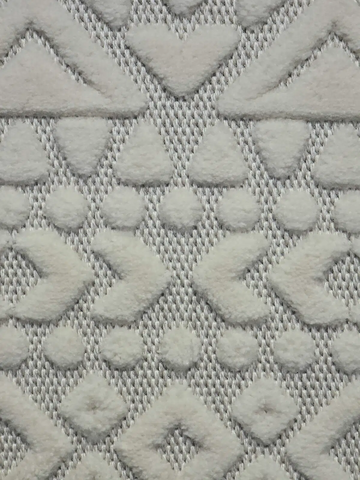 Extreme close-up of Nova rug’s triangle and dot shapes with high-pile finish