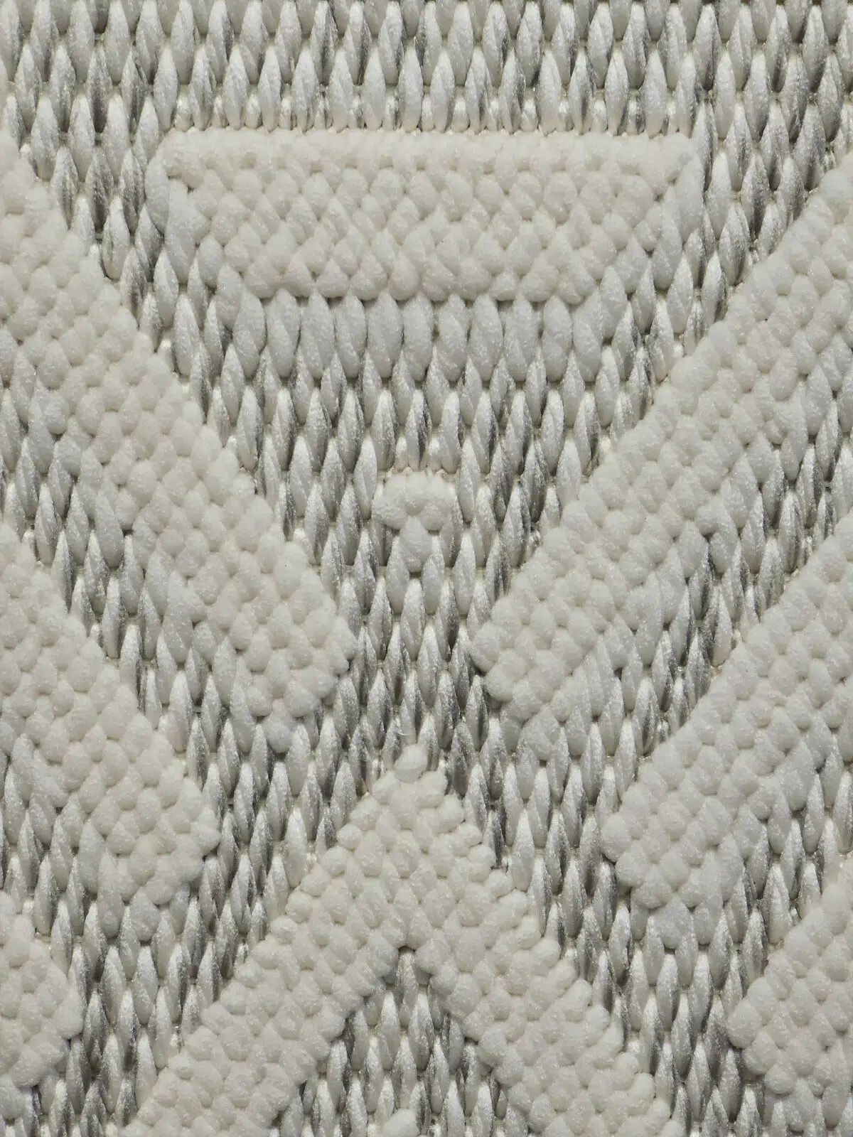 macro view of Solaris Rug showing plush white pile and sharp weave