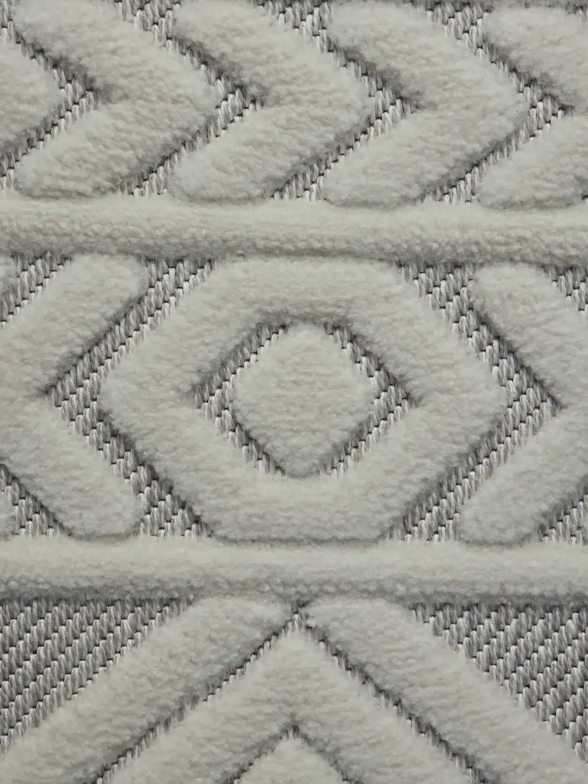 Macro shot of Luna rug’s texture with soft white raised weaving