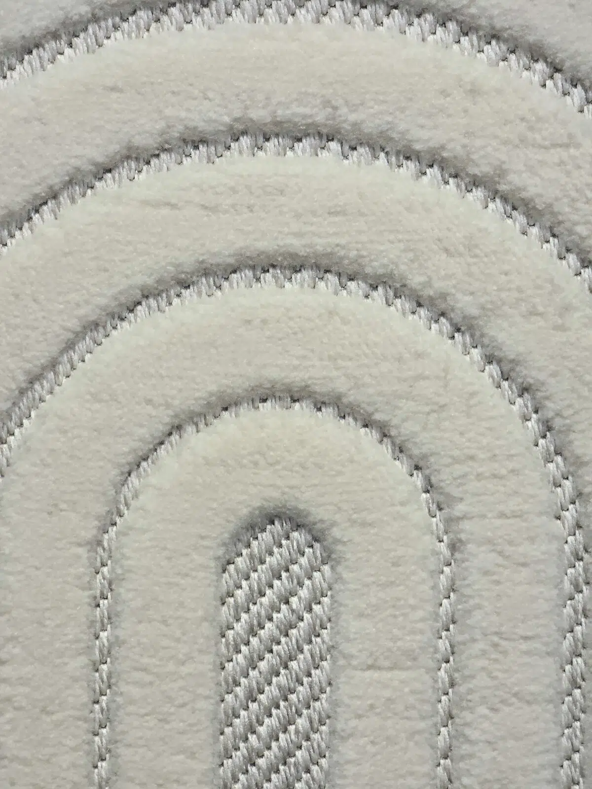 Extreme close-up of Orion rug’s plush arched design in white