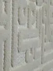 Side macro view of Aurora rug’s raised feather lines