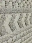 Angled view showing the 3D raised effect of geometric elements on Equinox rug