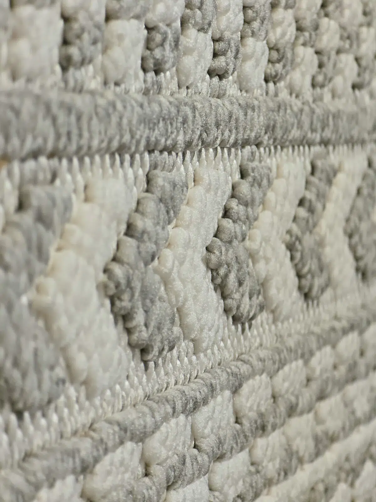 Angled view showing the 3D raised effect of geometric elements on Equinox rug