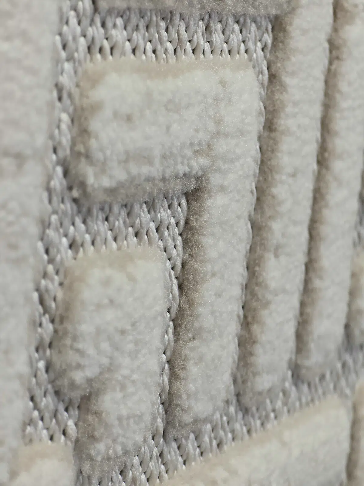 Angled close-up view of textured velvet pattern on Lyra carpet