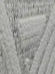 diagonal side view showing elevated beige patterns on Solaris Rug