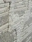 Side closeup of Twilight Rug showing plush feel and woven relief pattern