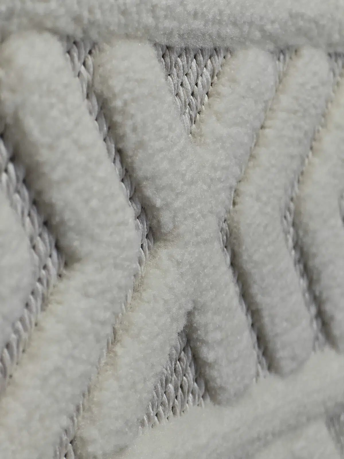 Side view close-up of white Luna rug showing plush V-patterns