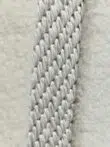 Yarn texture and weaving details of the Orion rug in soft white fibers