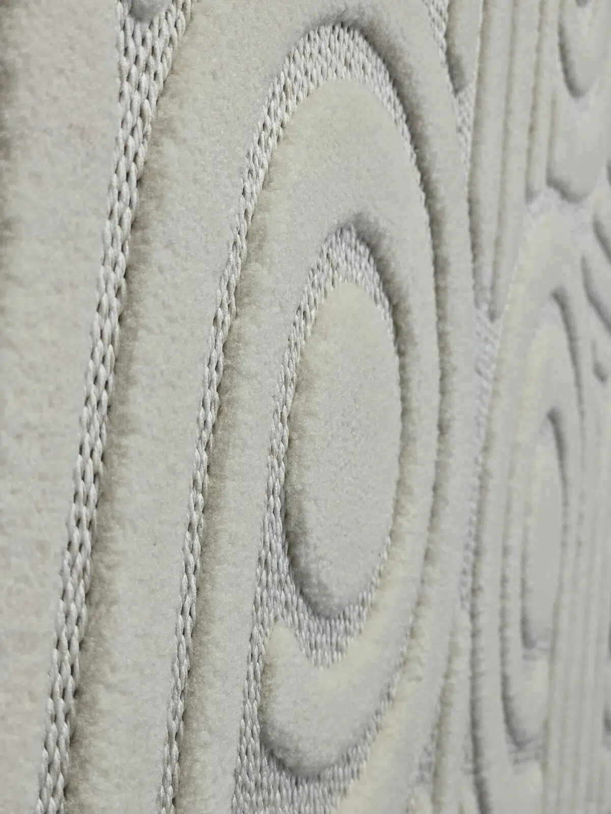 Angled close view showing concentric loop design and soft fabric on Nebula rug