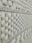 Macro view of vertical woven bands and grey-white squares on the Equinox carpet