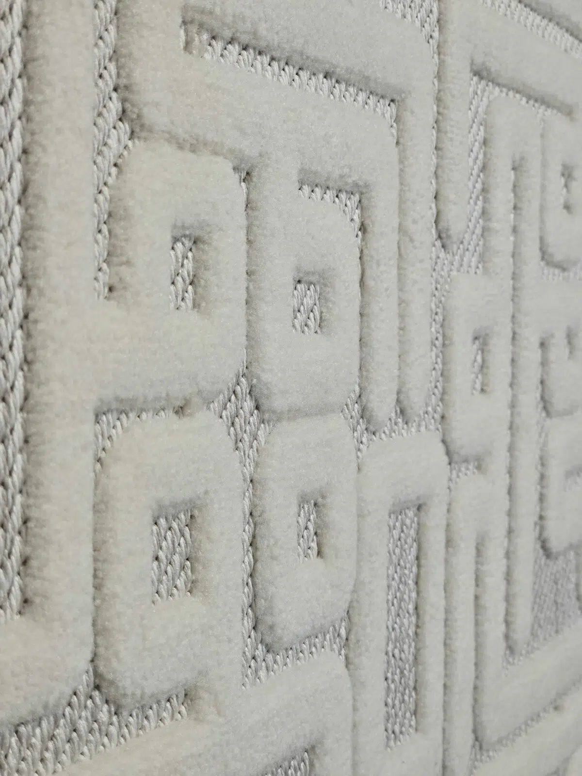 Oblique perspective of Vega Rug’s abstract Kufic design