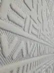 Angled image of Apollo Rug focusing on bold V-shaped and diamond patterns