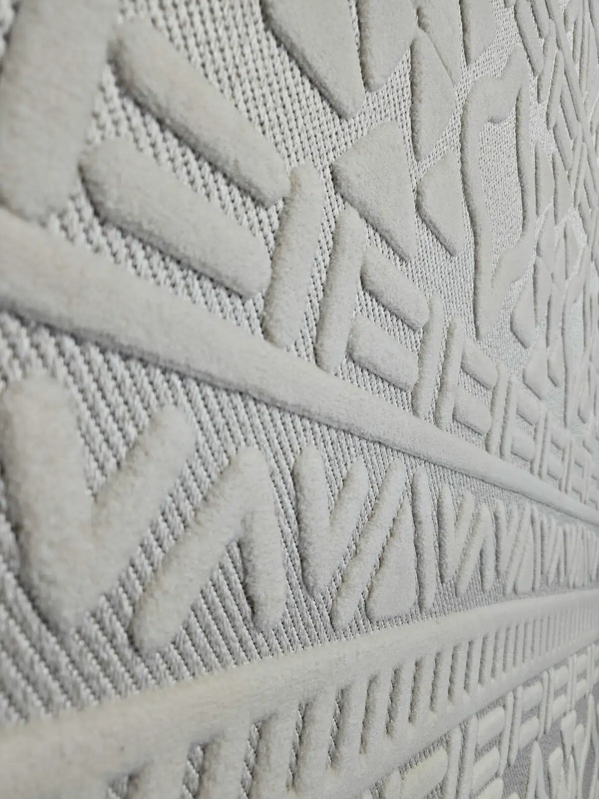 Angled image of Apollo Rug focusing on bold V-shaped and diamond patterns
