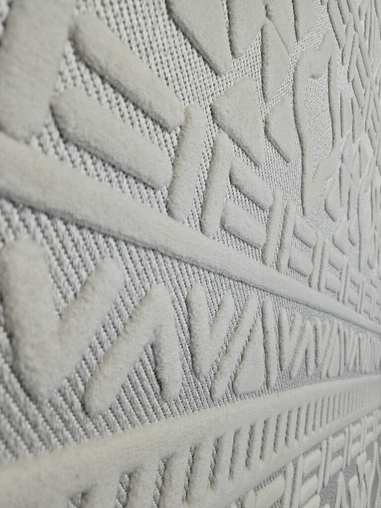 Angled image of Apollo Rug focusing on bold V-shaped and diamond patterns