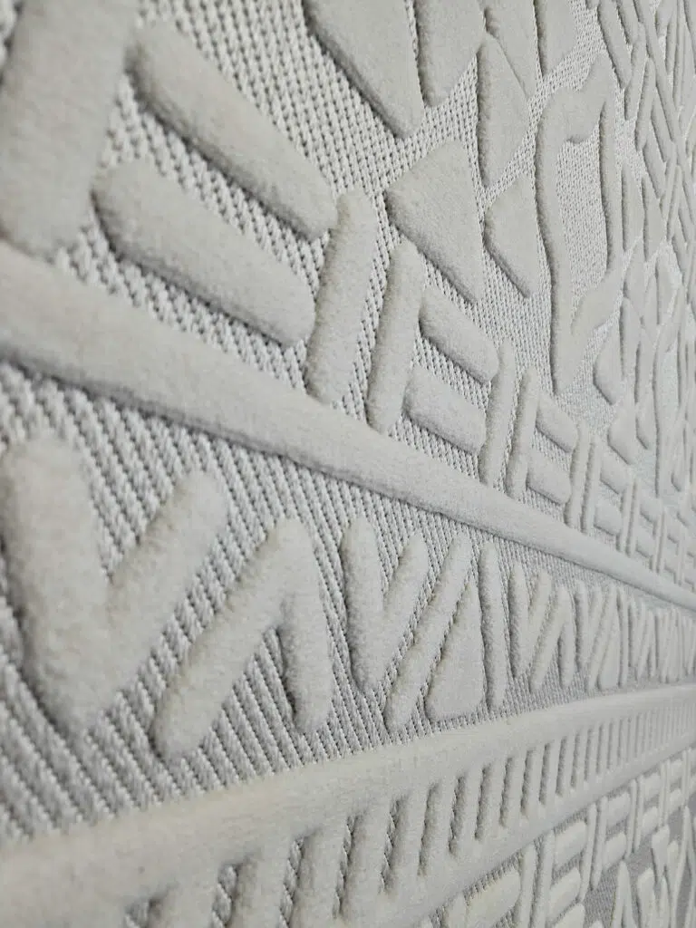 Angled image of Apollo Rug focusing on bold V-shaped and diamond patterns