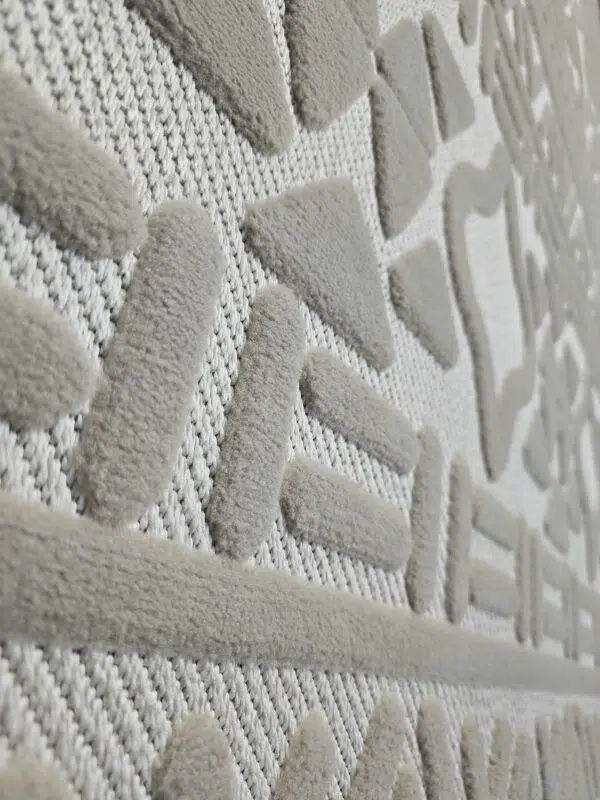 Side detail of Eclipse rug’s linear and dot motif finish