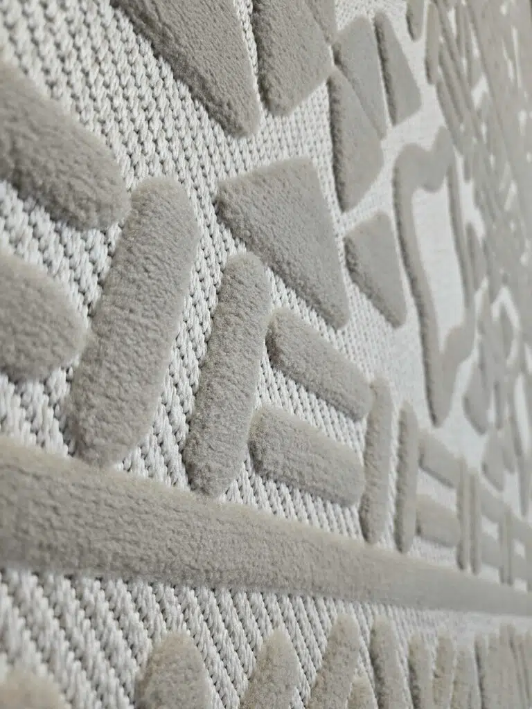 Side detail of Eclipse rug’s linear and dot motif finish