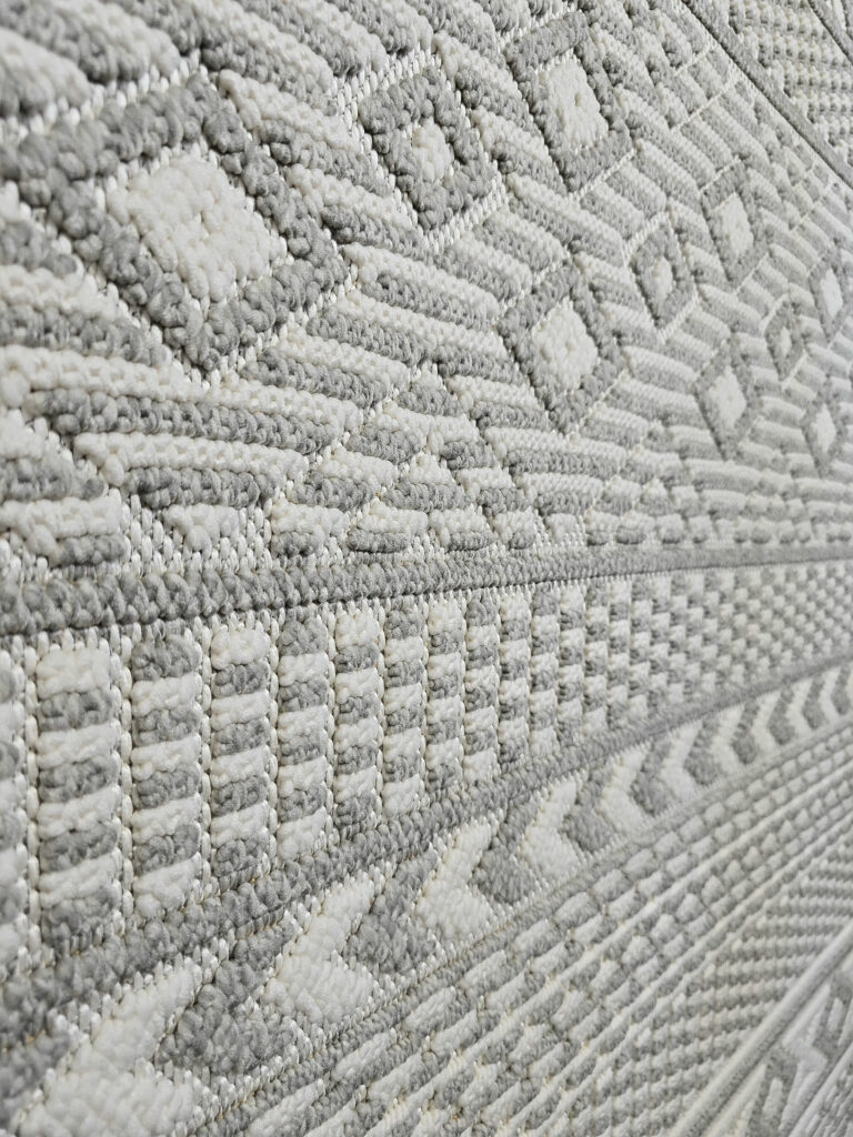 Close-up of plush grey and ivory vertical weave on Equinox rug
