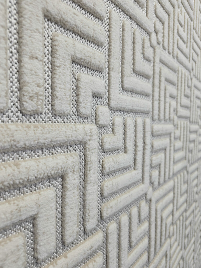 Raised texture of modern Lyra carpet pattern in side angle view