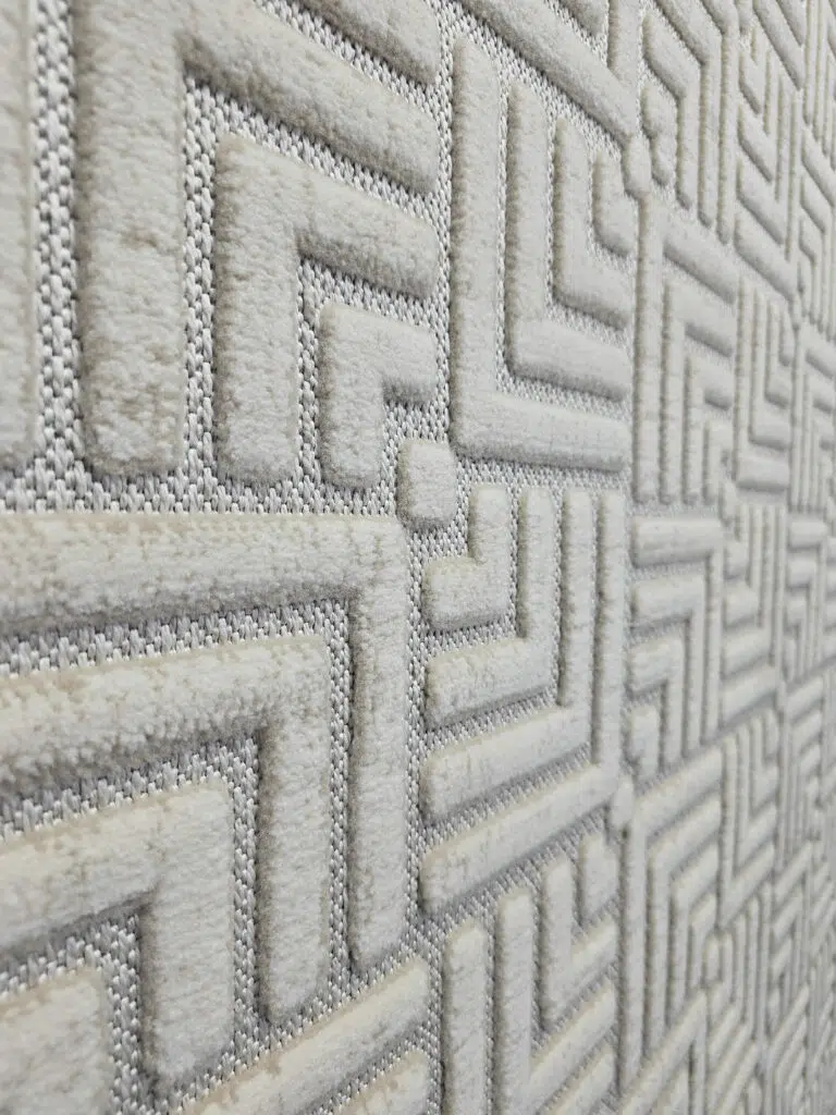 Raised texture of modern Lyra carpet pattern in side angle view