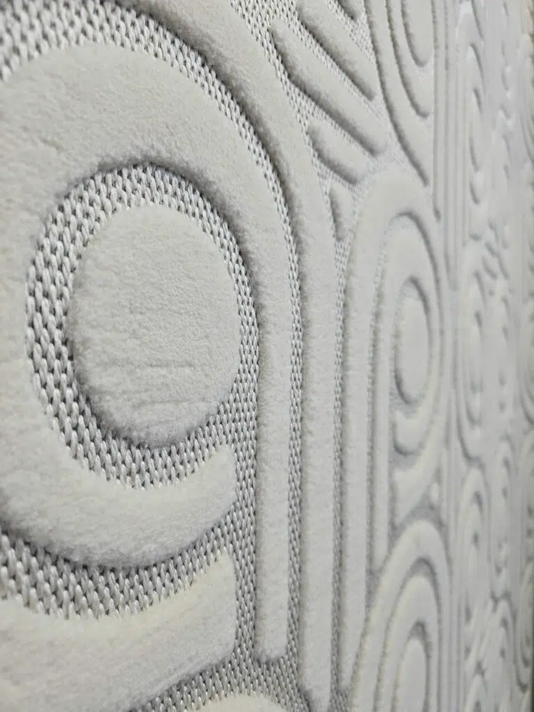 Side pattern view of Nebula carpet showing round and linear raised shapes