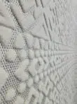 Macro detail of Nova rug’s dots and chevron lines in white