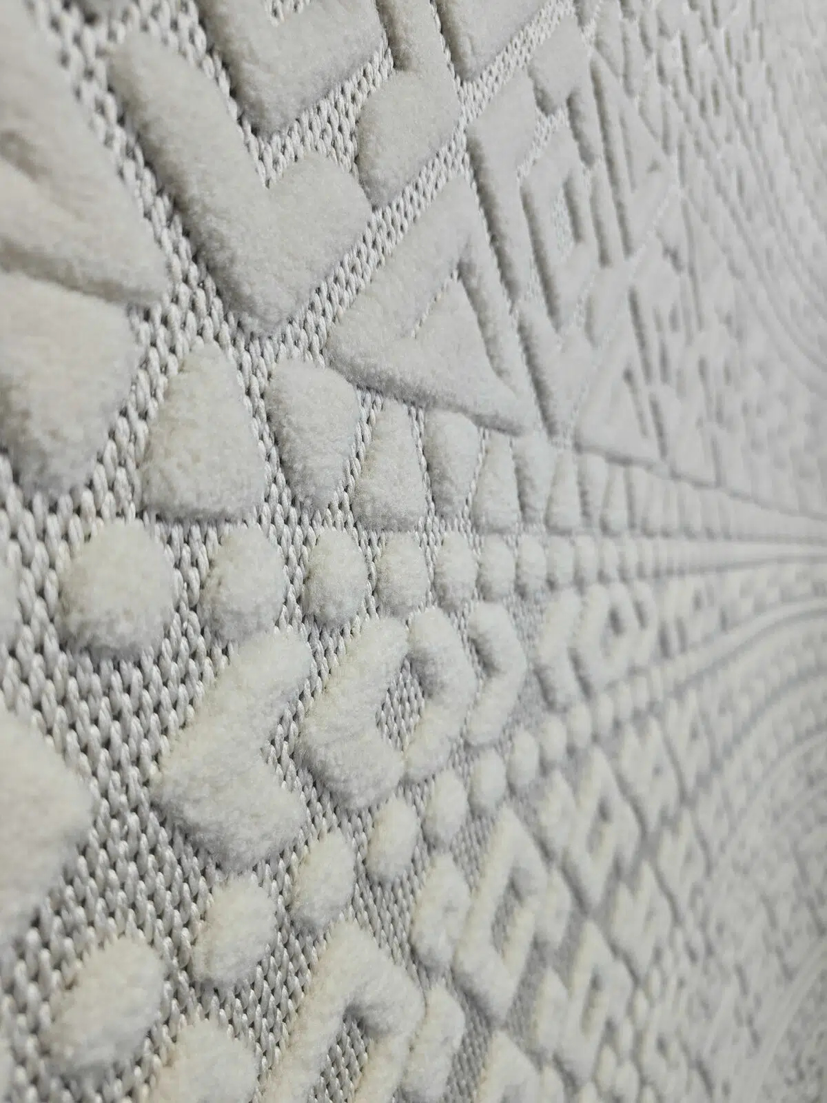 Macro detail of Nova rug’s dots and chevron lines in white