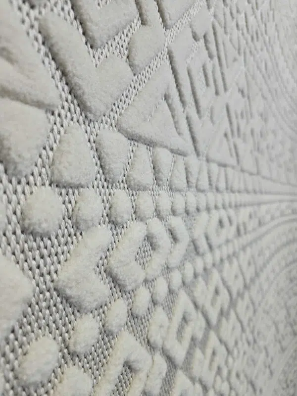 Macro detail of Nova rug’s dots and chevron lines in white