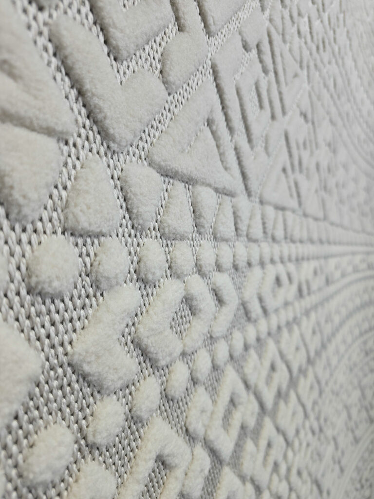 Macro detail of Nova rug’s dots and chevron lines in white