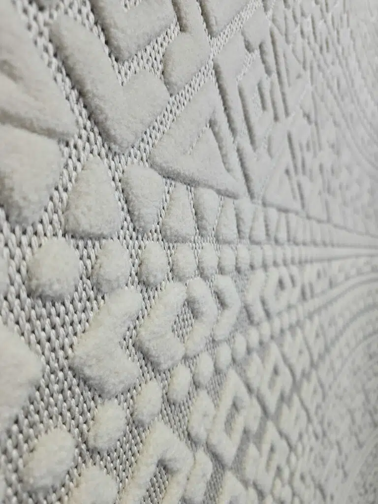 Macro detail of Nova rug’s dots and chevron lines in white