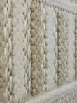 Detailed texture view of beige and white stripes on Radiant rug