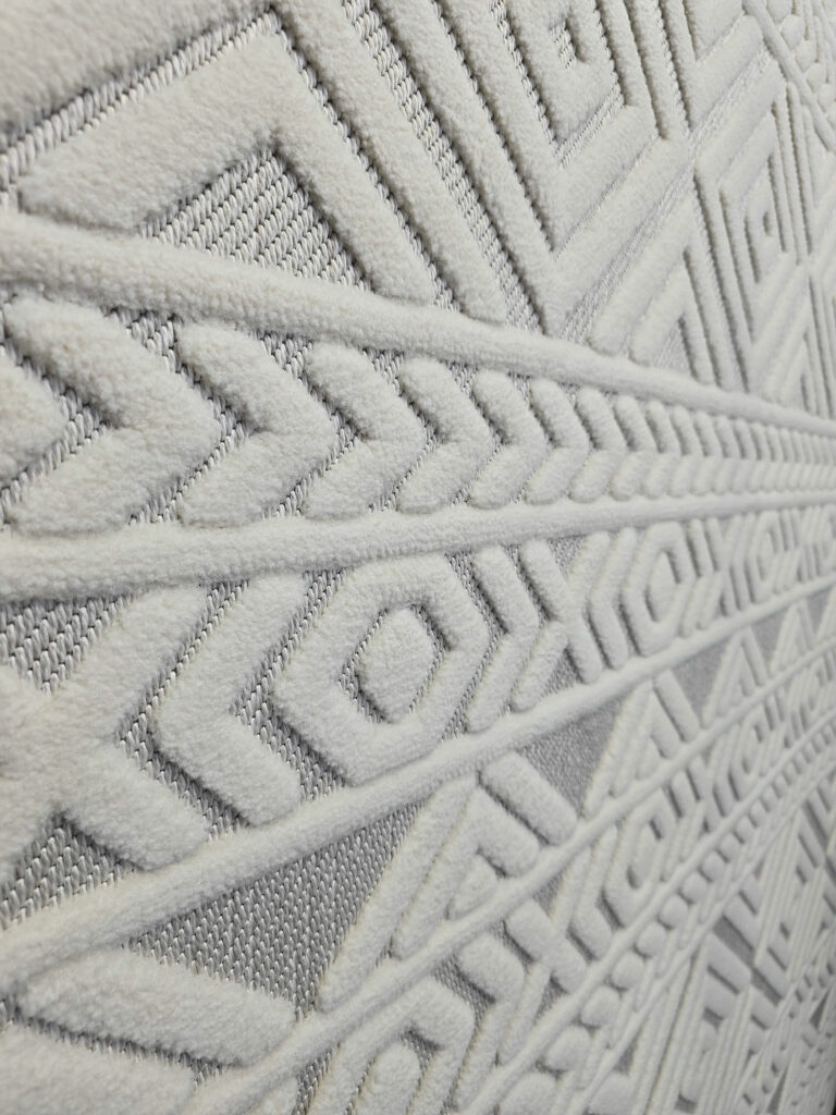 Side wide view of Luna rug displaying layered geometric patterns