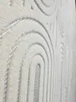 Wide side angle of Orion rug showing repeating arches and soft texture