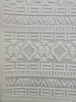 Bottom part of Apollo Rug showing rich pattern repetition in cream
