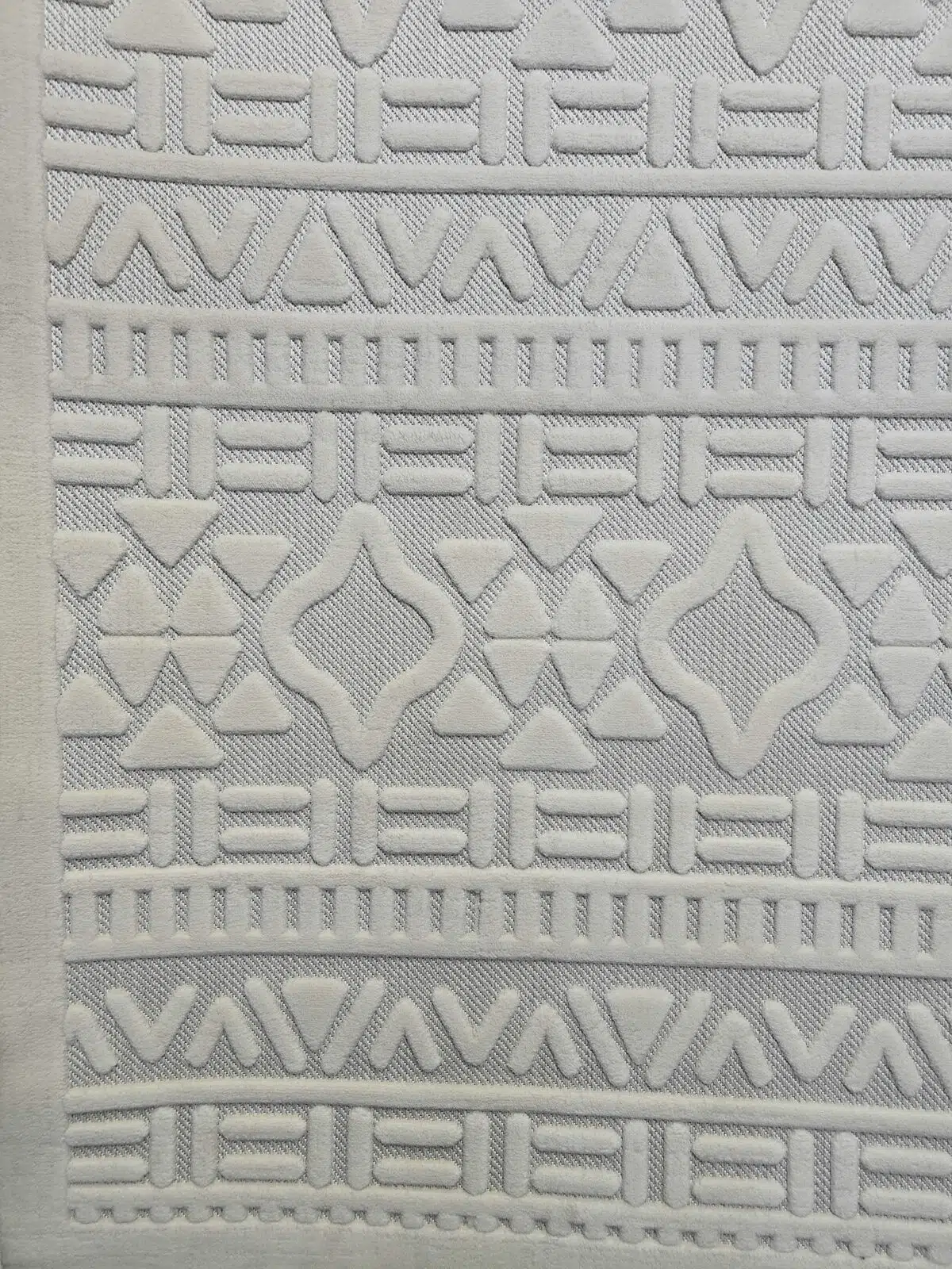 Bottom part of Apollo Rug showing rich pattern repetition in cream