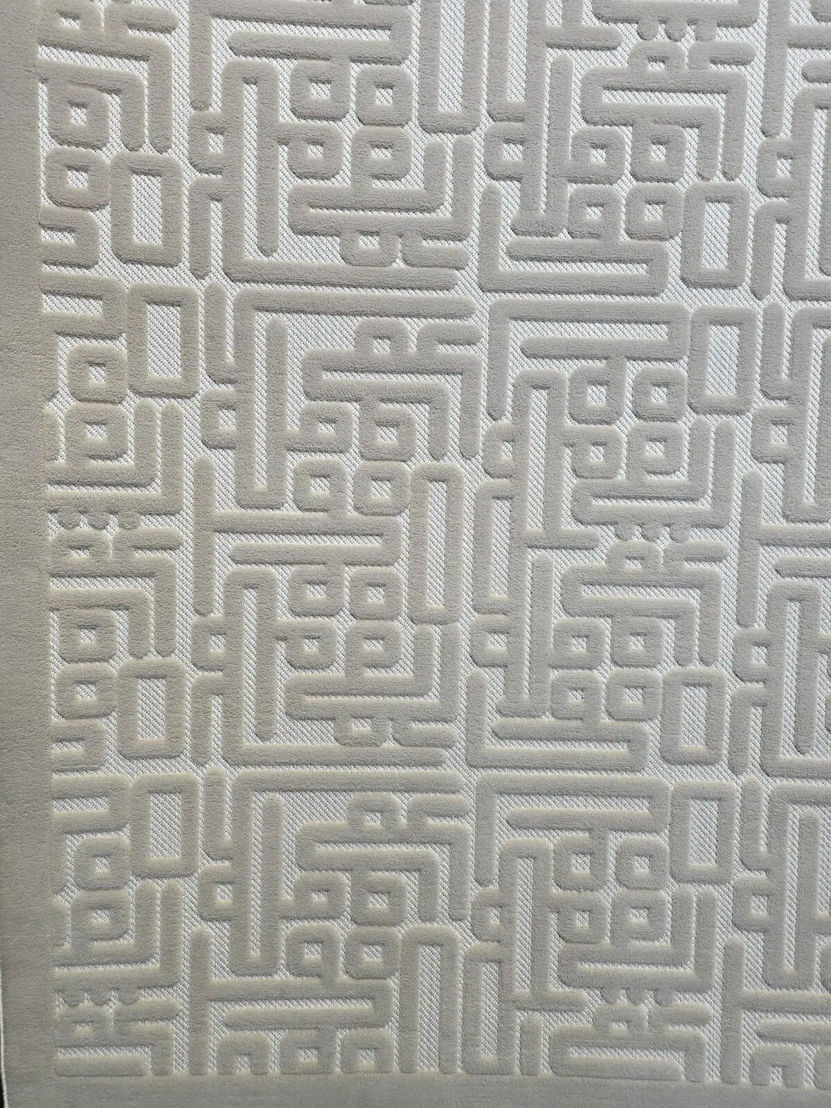 Flowing lines in Aurora rug’s raised geometric design