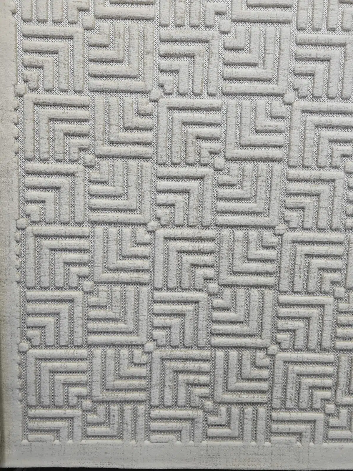 Angled photo showing the geometric grid pattern of Lyra rug