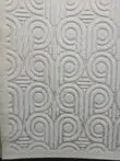 Angled shot of Nebula rug’s full pattern showing repeating retro curves