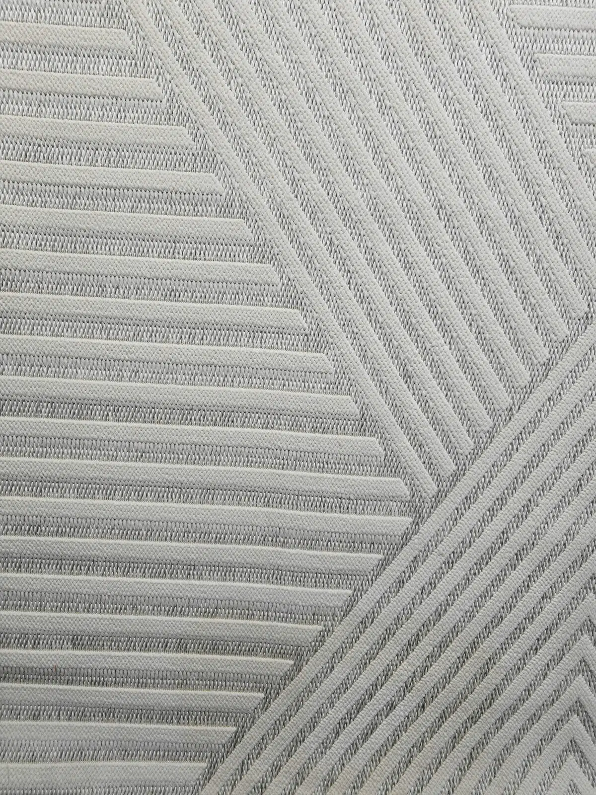angled close-up showing Solaris Rug’s layered chevron motif