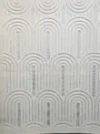 Lower part of Orion rug showcasing elegant curved lines in soft white